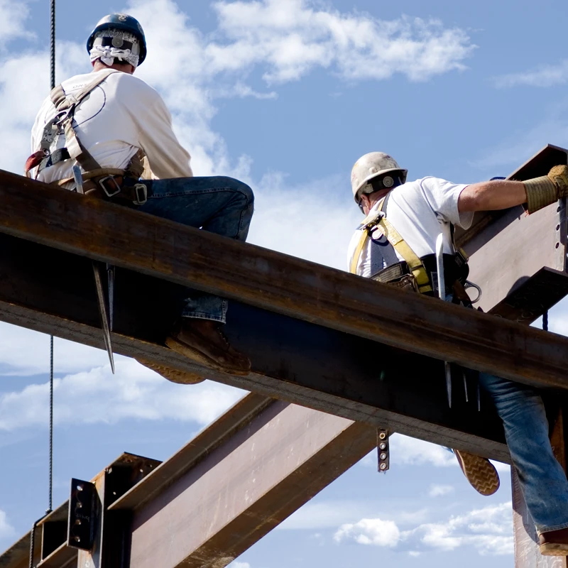 men sitting on metal structure